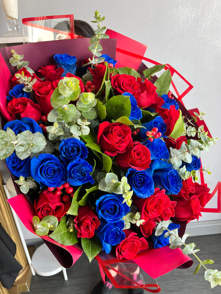 A Wrapped Bouquet of Blue and Red Roses