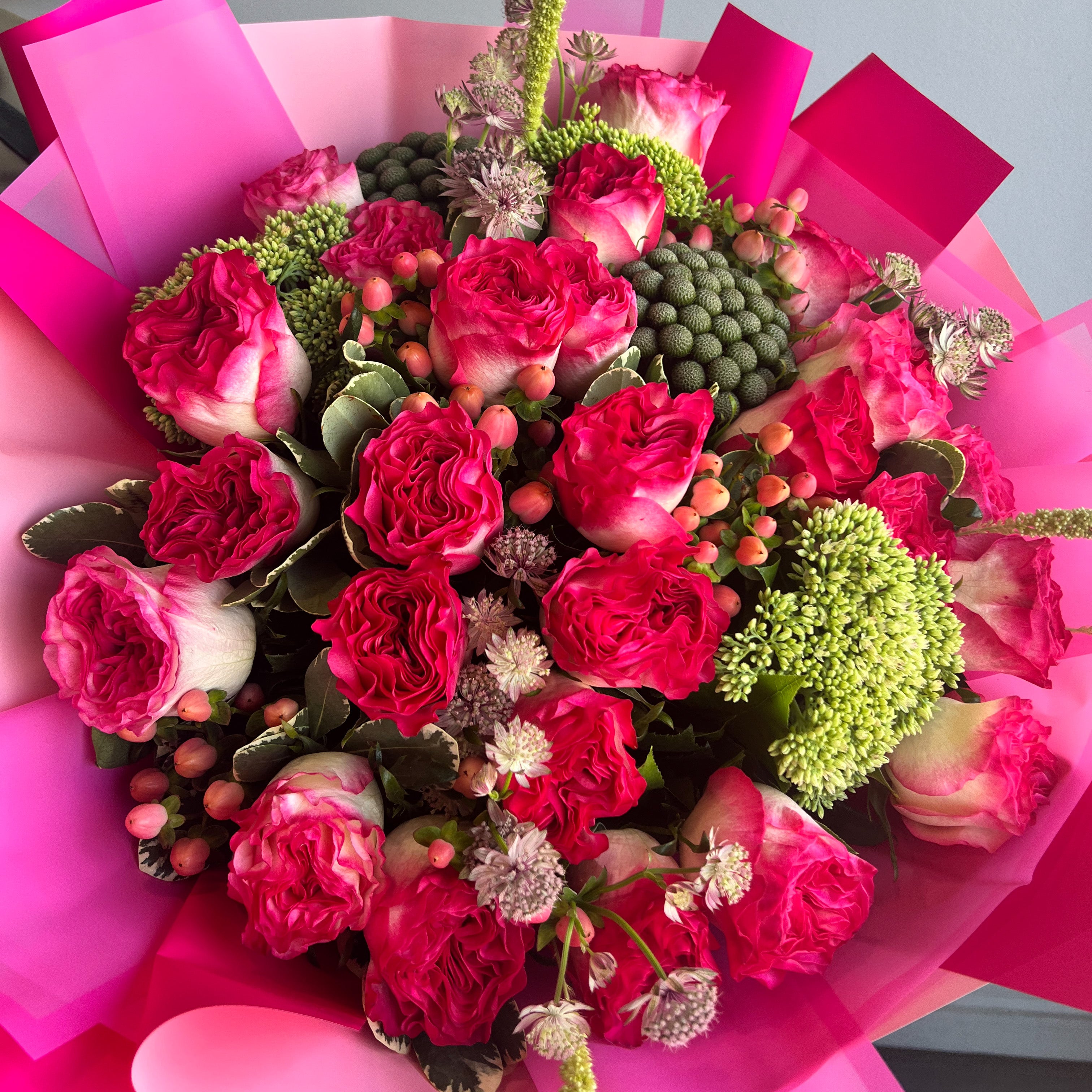 A wrapped Bouquet of Two Toned Pink Roses