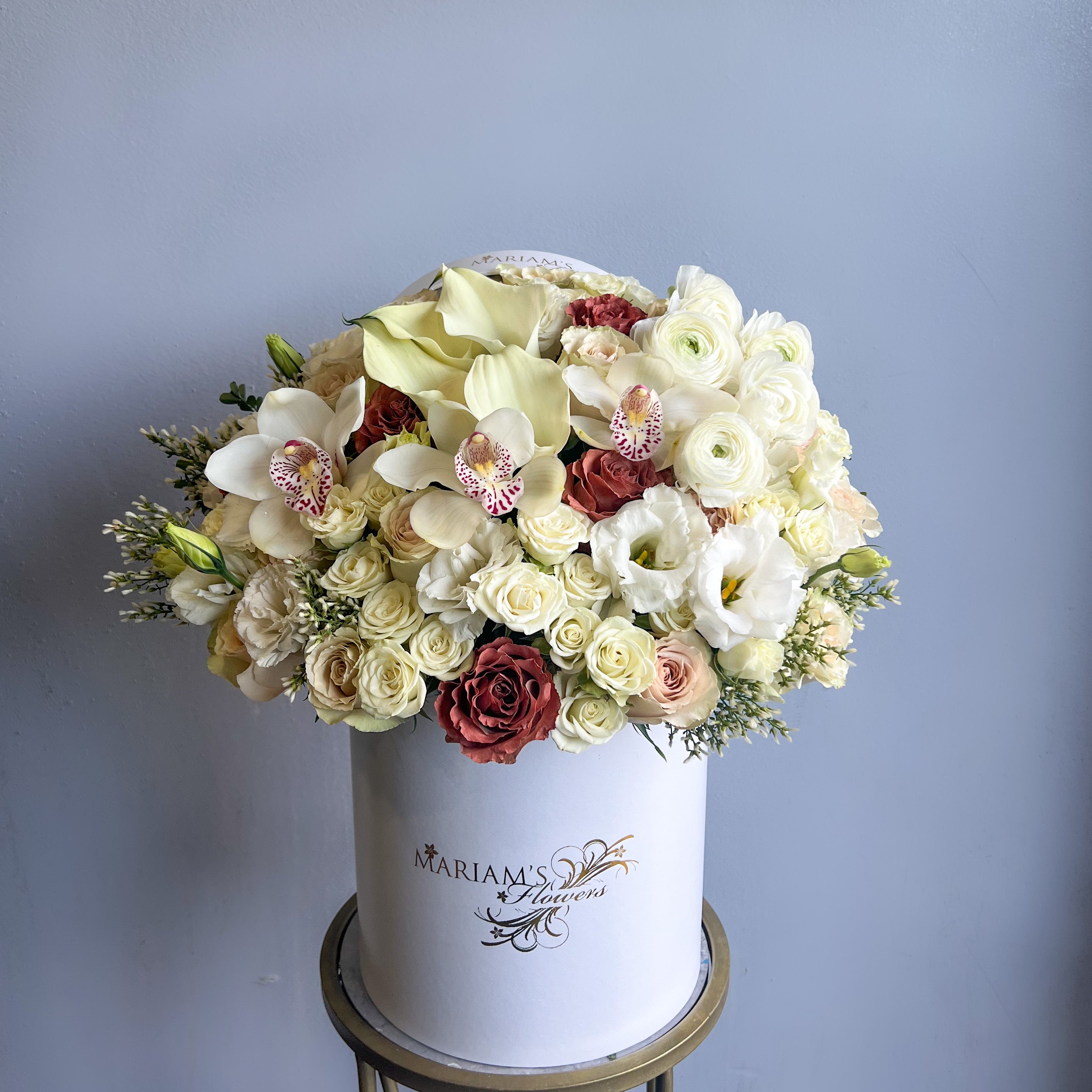 A white box filled with vibrant flowers, showcasing the Little Prince Bloom Box floral arrangement