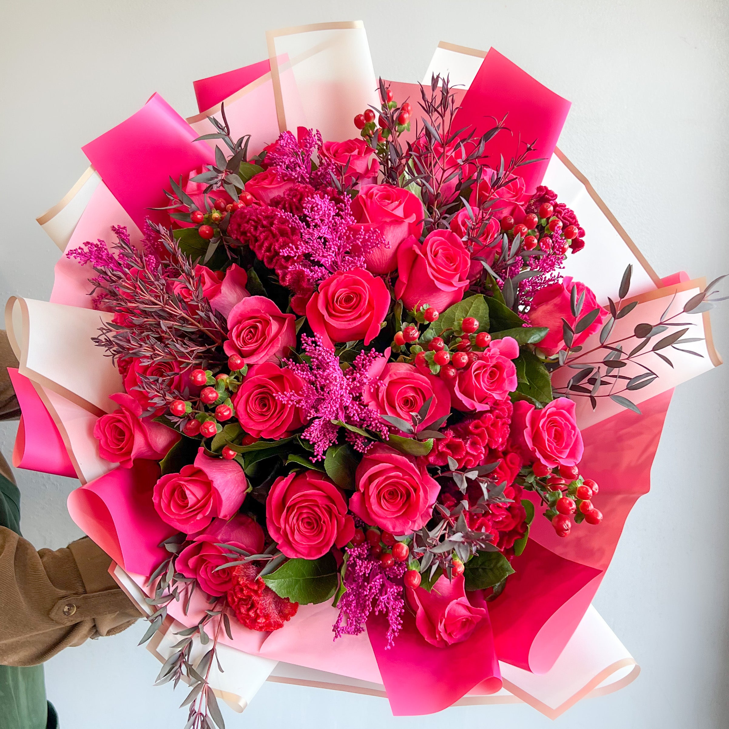 A wrapped Bouquet of Hot Pink Roses