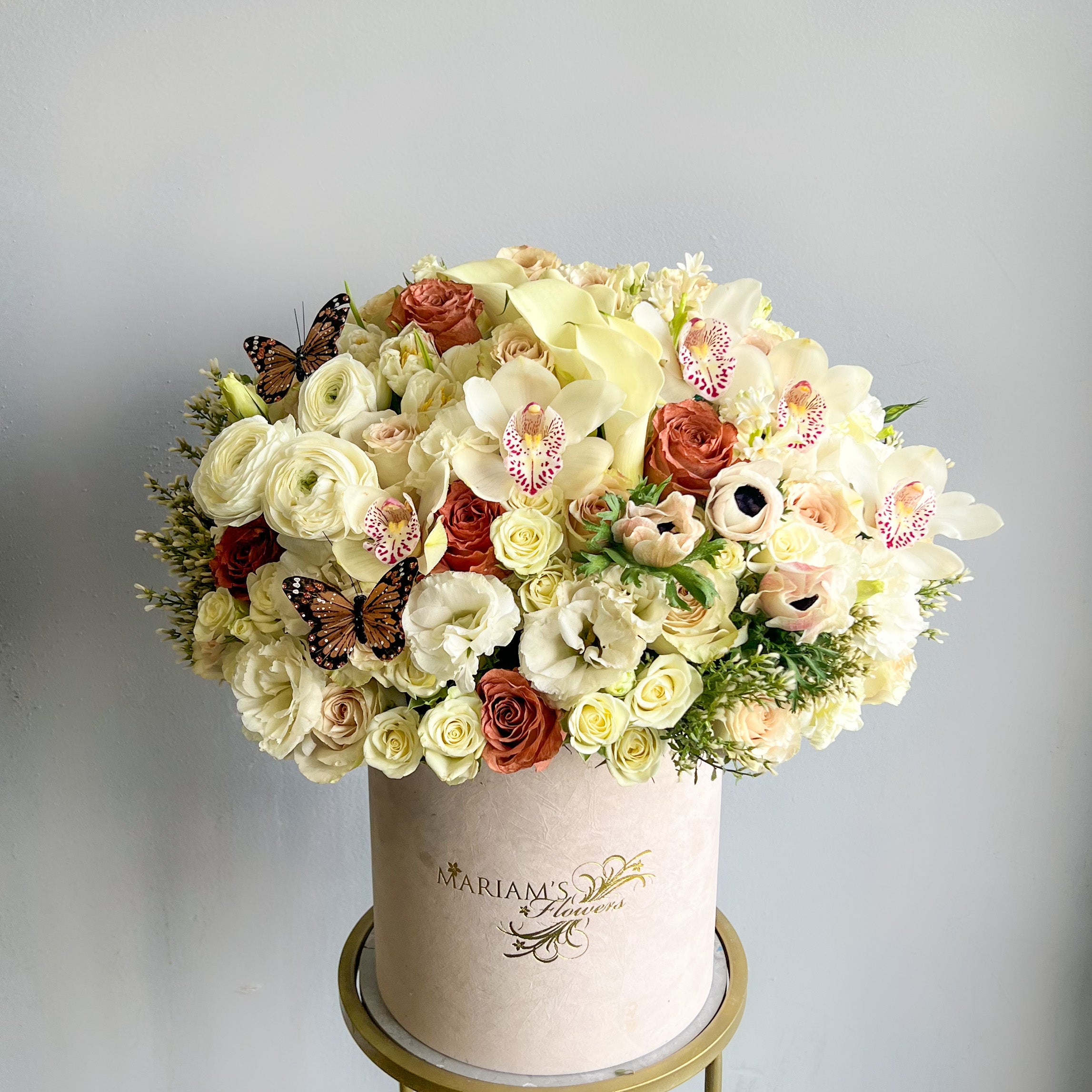 A white box filled with vibrant flowers, showcasing the Little Prince Bloom Box flower arrangements