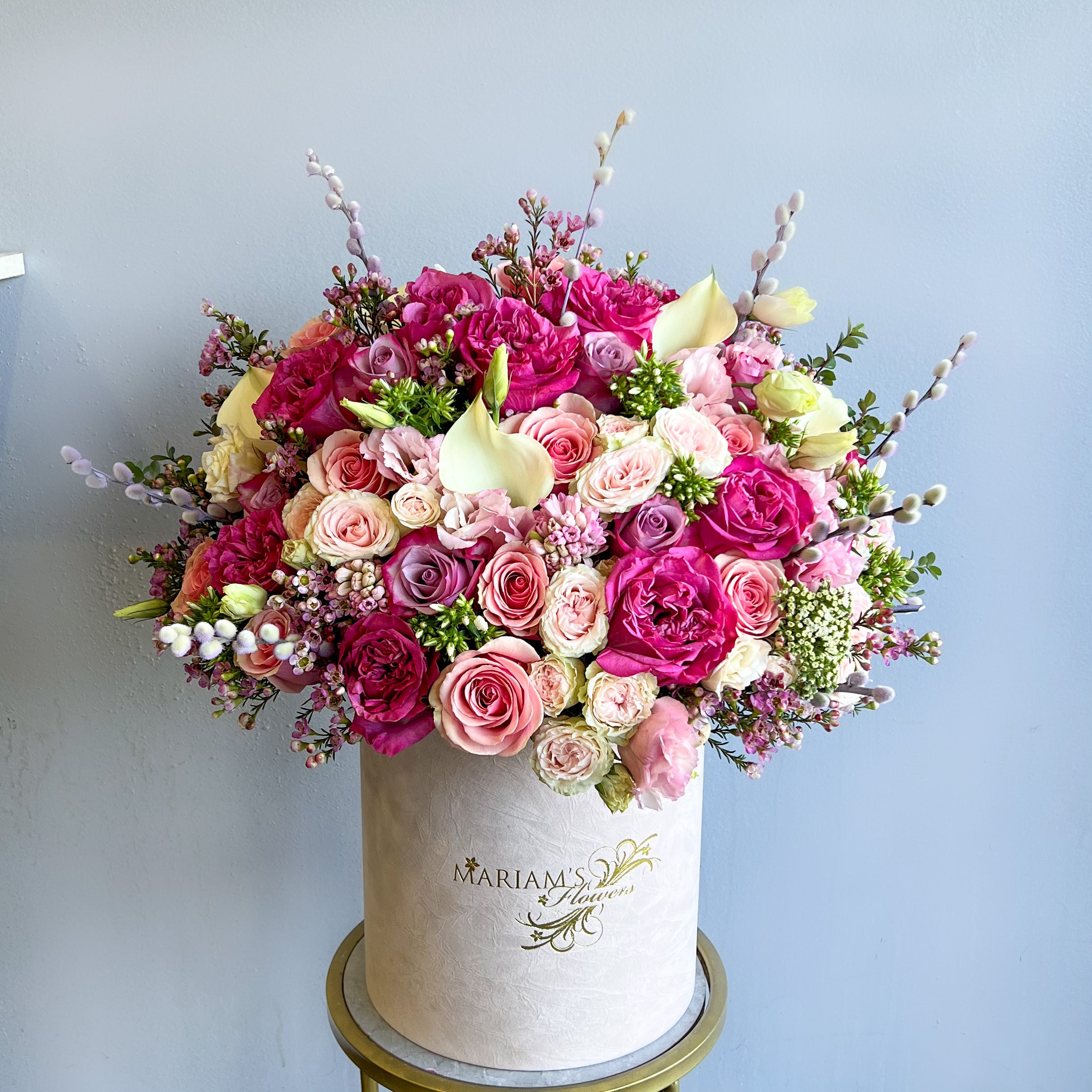 A white box featuring a beautiful arrangement of pink and white flowers from Blossom Breeze.