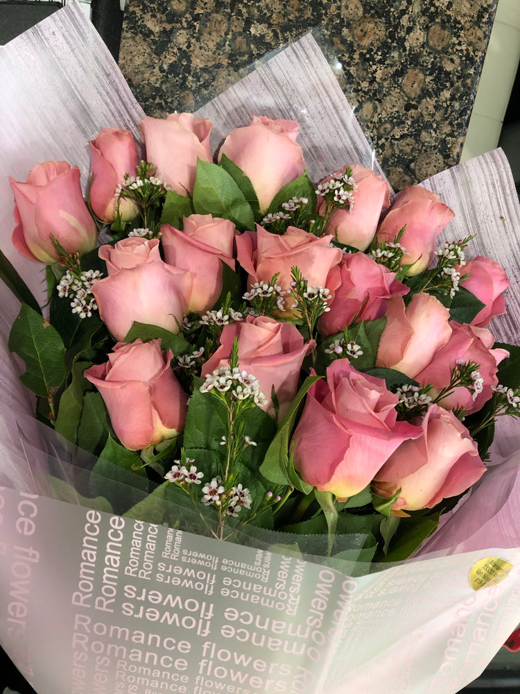 A Wrapped Bouquet of Pink Roses